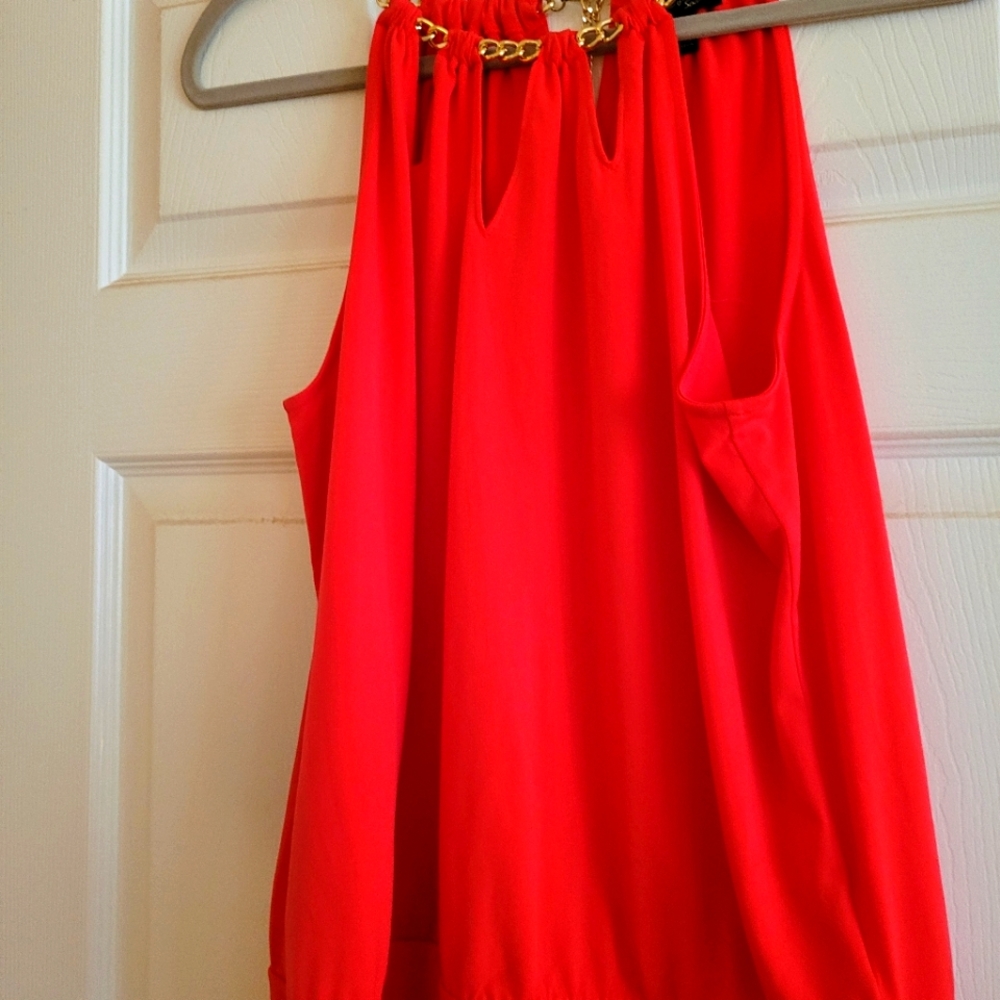 Ladies red top with chain link at neckline.